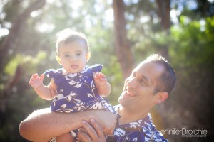 Dad and daughter having some fun for a family photo session and portraits at the beach.